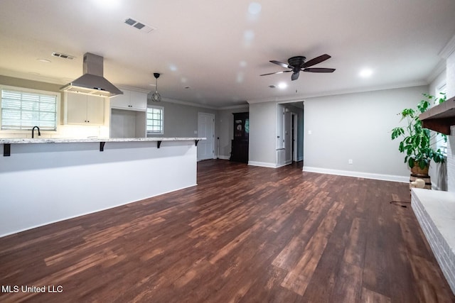unfurnished living room with crown molding, dark wood-style floors, ceiling fan, recessed lighting, and baseboards