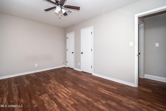 unfurnished bedroom with wood finished floors, baseboards, and a ceiling fan