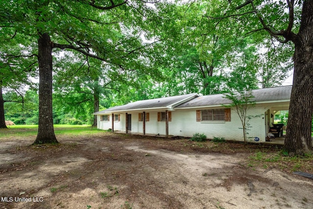 single story home featuring brick siding