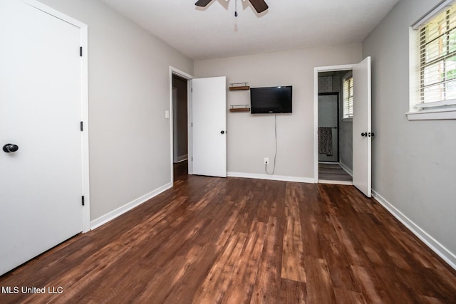 unfurnished bedroom with wood finished floors, baseboards, and ceiling fan