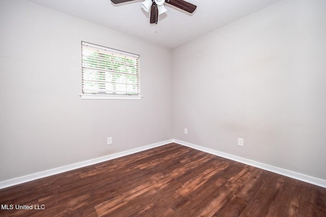 spare room featuring a ceiling fan, baseboards, and dark wood finished floors