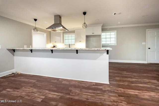 kitchen with range hood, ornamental molding, a kitchen breakfast bar, baseboards, and light stone countertops