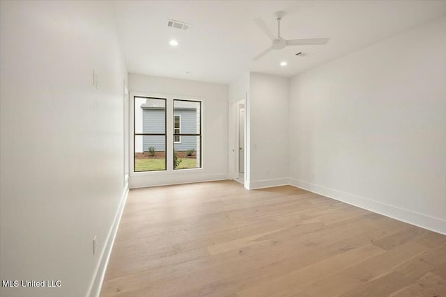 spare room with light wood-type flooring, baseboards, recessed lighting, a ceiling fan, and visible vents