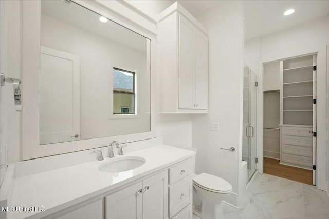 bathroom featuring a shower stall, vanity, recessed lighting, toilet, and marble finish floor