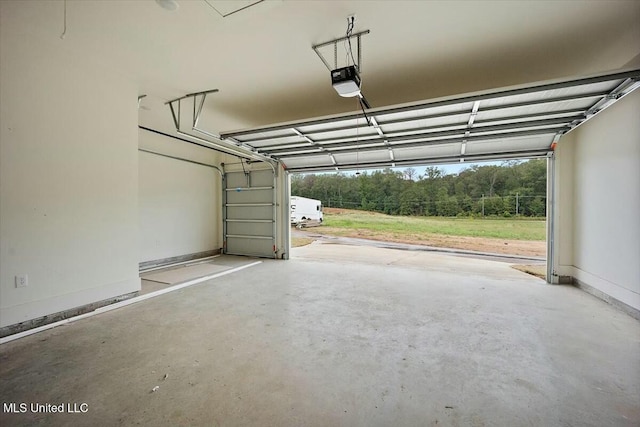 garage featuring a garage door opener and baseboards