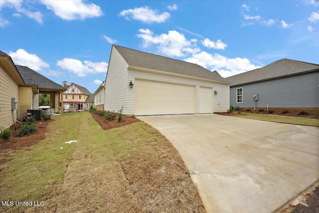 view of property exterior with concrete driveway, a yard, central AC, and an attached garage