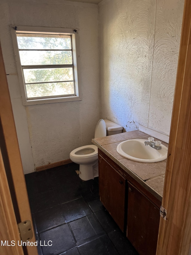 bathroom featuring vanity and toilet