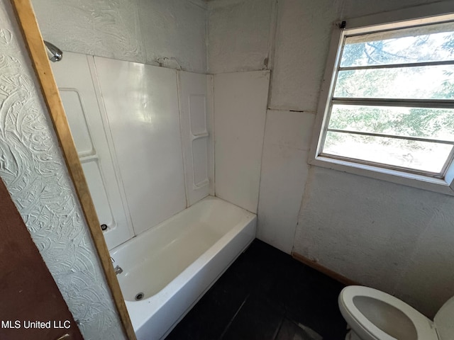 bathroom featuring a bathing tub and toilet