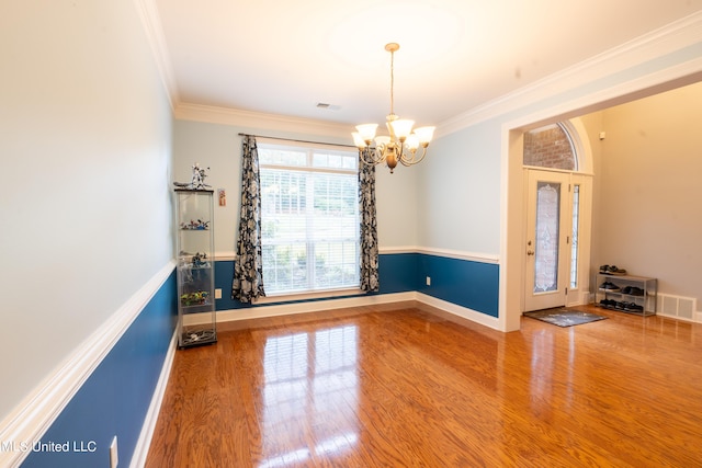 890 Lindsey Cv, Hernando, MS 38632 - empty room with a chandelier, ornamental molding, wood finished floors, and baseboards