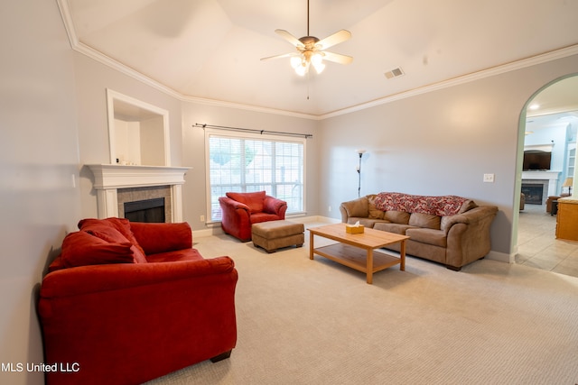 carpeted living room with crown molding, lofted ceiling, a fireplace, and ceiling fan