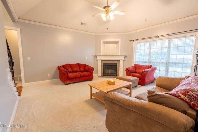 890 Lindsey Cv, Hernando, MS 38632 - living area with ceiling fan, vaulted ceiling, a tile fireplace, light carpet, and baseboards