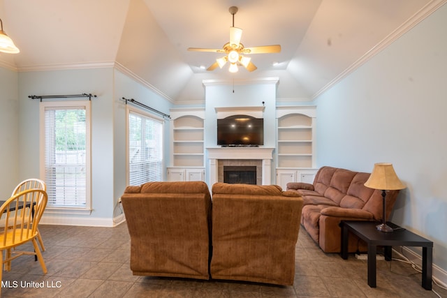 890 Lindsey Cv, Hernando, MS 38632 - tiled living area with a ceiling fan, baseboards, a tiled fireplace, vaulted ceiling, and built in shelves