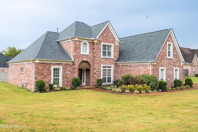 890 Lindsey Cv, Hernando, MS 38632 - view of front of property with a shingled roof, brick siding, and a front lawn