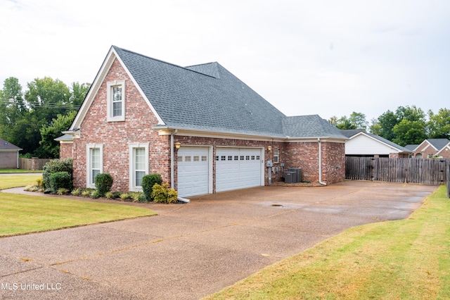 view of front of house featuring a front yard and central AC