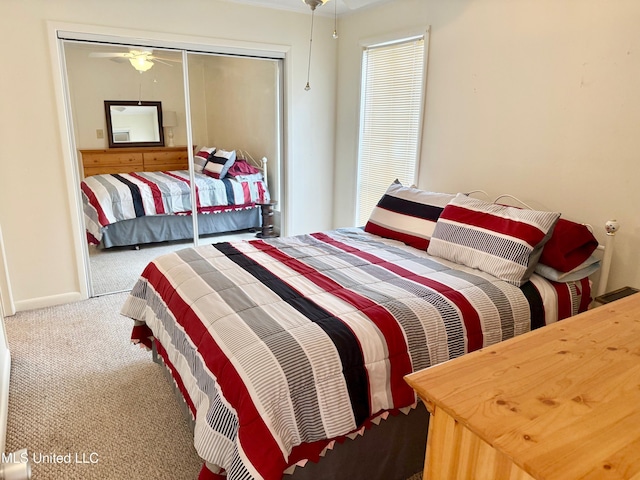 bedroom with carpet floors, a closet, and baseboards