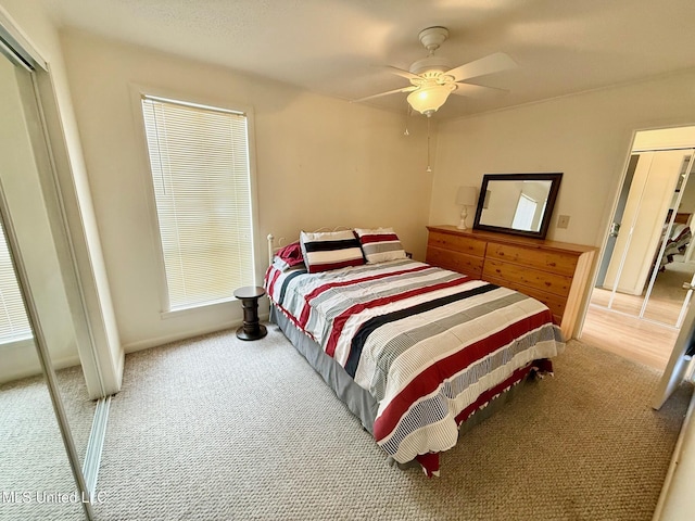 carpeted bedroom with ceiling fan