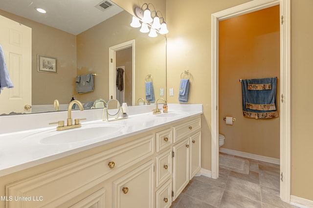 bathroom with vanity, tile patterned floors, and toilet