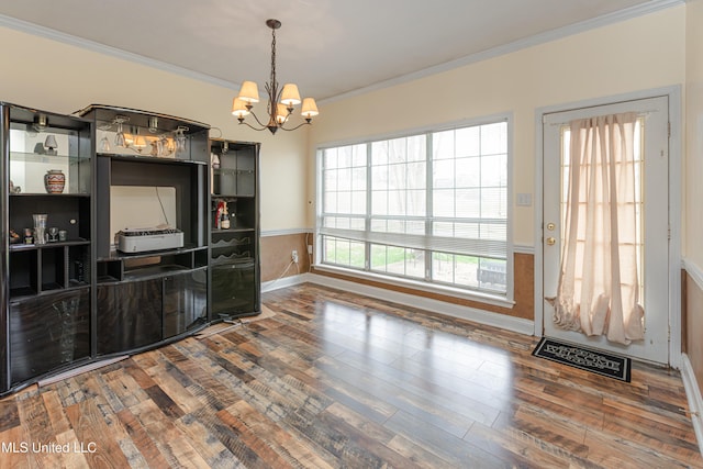 interior space with a notable chandelier, crown molding, and wood-type flooring