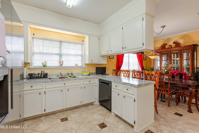 kitchen with dishwasher, plenty of natural light, ornamental molding, and white cabinets