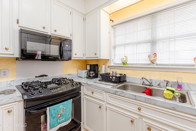 kitchen with white cabinetry, sink, and black appliances