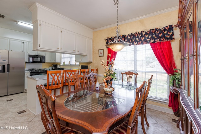 tiled dining area with crown molding and a wealth of natural light