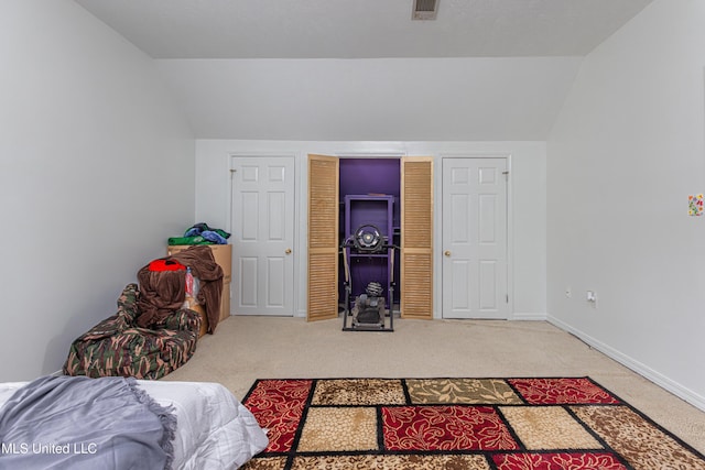 bedroom with lofted ceiling and light carpet