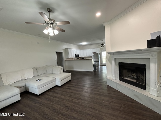 unfurnished living room featuring a fireplace, ceiling fan, dark hardwood / wood-style flooring, and crown molding