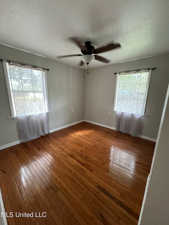 1607 Resca De La Palma St, Pascagoula, MS 39567 - unfurnished room featuring hardwood / wood-style flooring, a ceiling fan, a textured ceiling, and baseboards