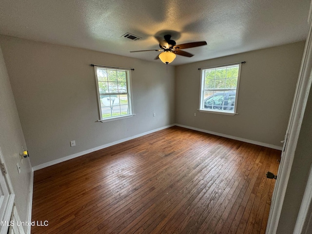 1607 Resca De La Palma St, Pascagoula, MS 39567 - unfurnished room with healthy amount of natural light, wood-type flooring, a textured ceiling, a ceiling fan, and baseboards