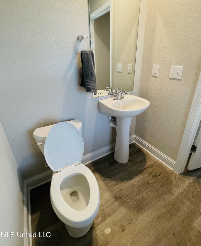 5438 Leeds Ln, Biloxi, MS 39532 - half bath with toilet, baseboards, and wood finished floors