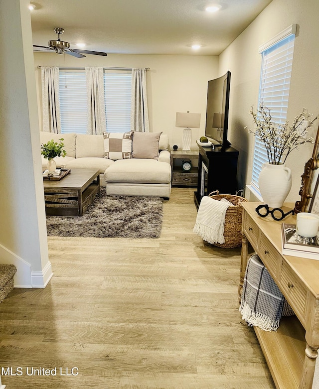 5438 Leeds Ln, Biloxi, MS 39532 - living room with baseboards, ceiling fan, a wealth of natural light, and light wood finished floors