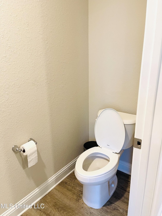 5438 Leeds Ln, Biloxi, MS 39532 - bathroom with baseboards, toilet, and wood finished floors