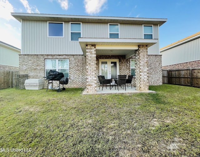 5438 Leeds Ln, Biloxi, MS 39532 - rear view of house featuring brick siding, a fenced backyard, and a yard