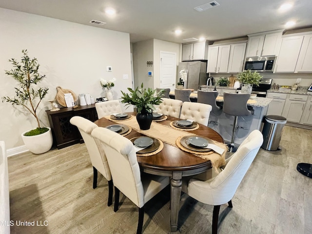 5438 Leeds Ln, Biloxi, MS 39532 - dining area with recessed lighting, baseboards, visible vents, and light wood-style flooring