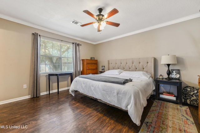 bedroom with a ceiling fan, baseboards, wood finished floors, visible vents, and ornamental molding