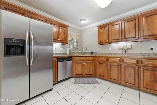 kitchen with a sink, crown molding, brown cabinetry, and stainless steel appliances