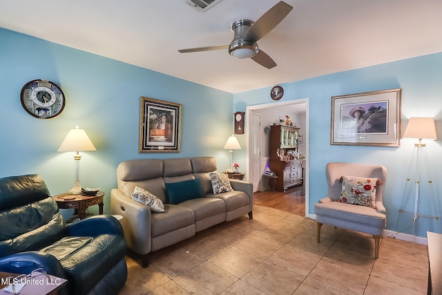 tiled living room with ceiling fan