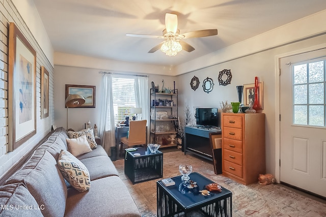 living room with ceiling fan and a wealth of natural light