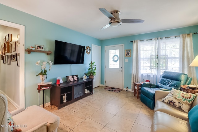 living room with ceiling fan and light tile patterned floors