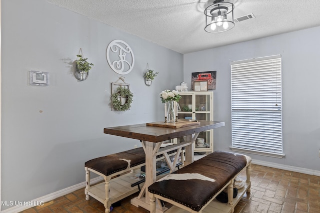 dining area with a textured ceiling