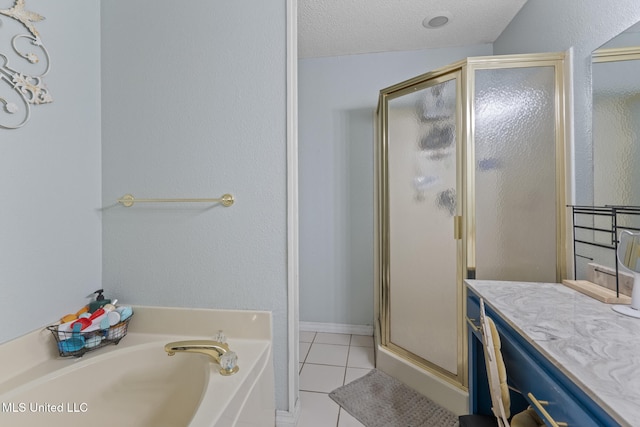 bathroom featuring vanity, tile patterned floors, plus walk in shower, and a textured ceiling