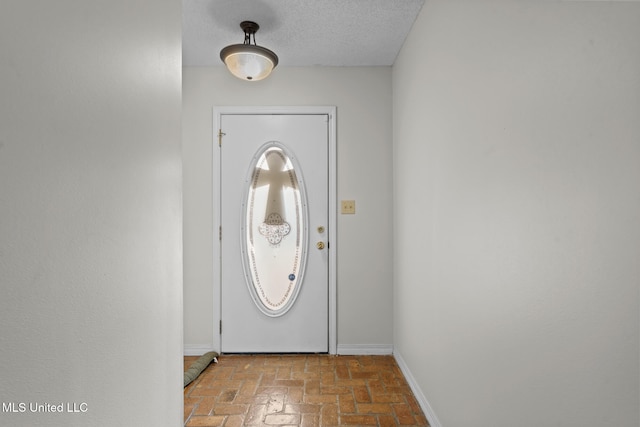 foyer entrance featuring a textured ceiling