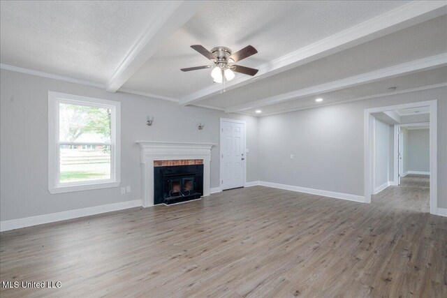 250 1st St, Webb, MS 38966 - unfurnished living room with beamed ceiling, a ceiling fan, light wood-style flooring, a textured ceiling, and a fireplace