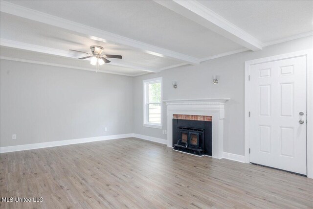 250 1st St, Webb, MS 38966 - unfurnished living room featuring beamed ceiling, light wood-style floors, ceiling fan, crown molding, and a fireplace