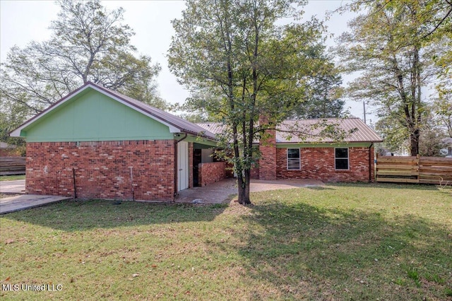 250 1st St, Webb, MS 38966 - rear view of house with brick siding, a patio, and metal roof