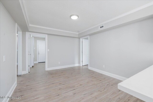 250 1st St, Webb, MS 38966 - spare room with light wood-style floors, a tray ceiling, baseboards, ornamental molding, and a textured ceiling
