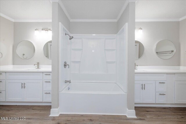 250 1st St, Webb, MS 38966 - full bathroom with washtub / shower combination, wood finished floors, two vanities, and ornamental molding