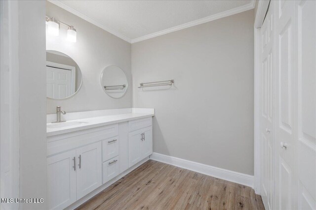 250 1st St, Webb, MS 38966 - bathroom featuring ornamental molding, wood finished floors, vanity, and baseboards