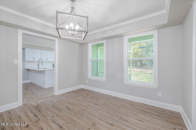 250 1st St, Webb, MS 38966 - empty room with a chandelier, light wood-style floors, baseboards, a sink, and ornamental molding