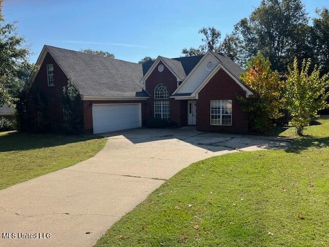 view of front of home featuring a front yard and a garage